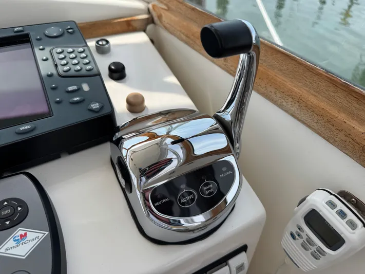 Wrecking Crew Yacht Photos Pics Boat control panel with chrome throttle lever, electronic display, and communication device on a Fortier 26, 2006.
