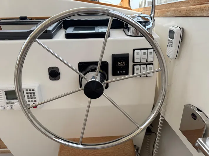 Wrecking Crew Yacht Photos Pics Steering wheel and controls of a 2006 Fortier 26 boat cockpit.