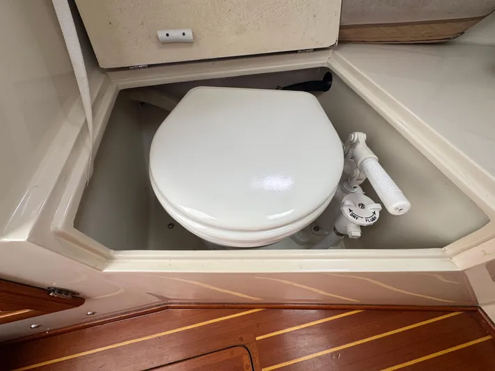 Wrecking Crew Yacht Photos Pics Boat toilet in a 2006 Fortier 26, featuring a manual flush system.