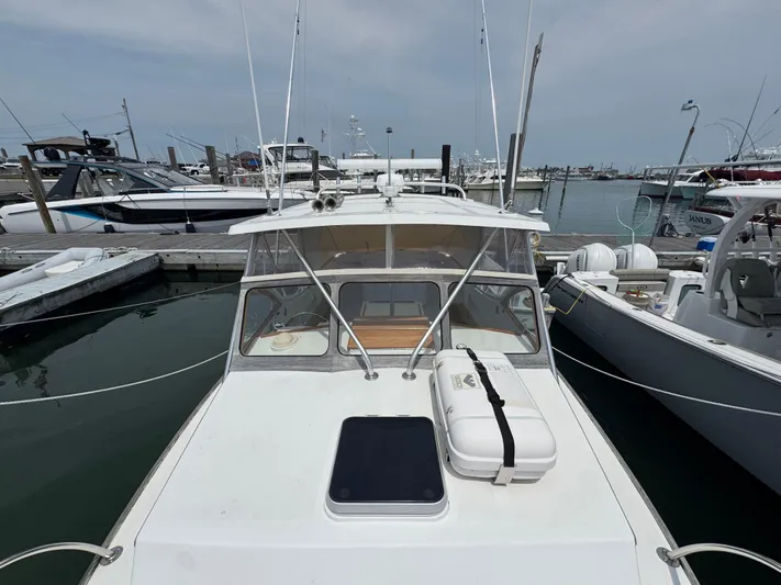 Wrecking Crew Yacht Photos Pics 2006 Fortier 26 boat docked at marina, surrounded by other vessels.