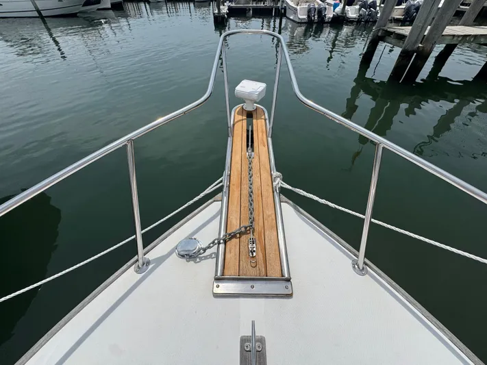 Wrecking Crew Yacht Photos Pics Bow of 2006 Fortier 26 boat with anchor chain, docked in marina.