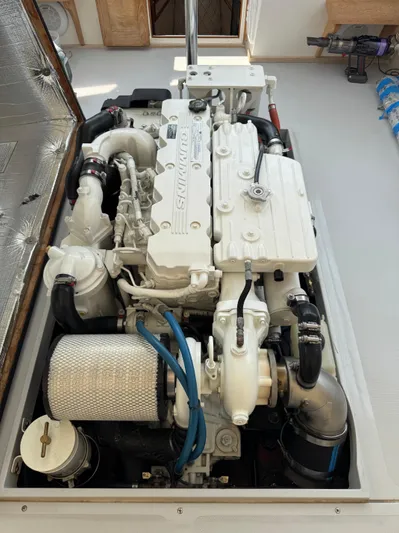 Wrecking Crew Yacht Photos Pics Engine compartment of a 2006 Fortier 26 boat, featuring a Cummins marine engine.