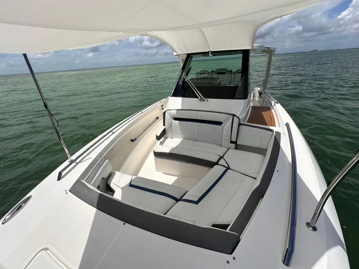  Yacht Photos Pics 2021 Tiara Sport 34 LS boat with spacious seating on calm waters.