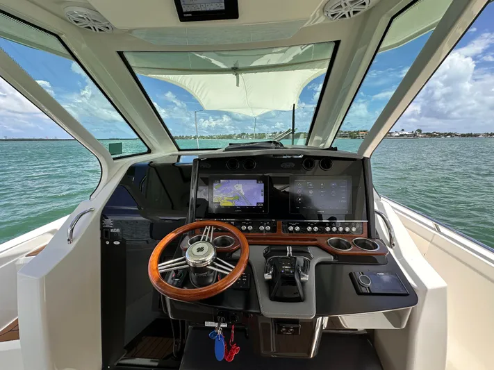  Yacht Photos Pics 2021 Tiara Sport 34 LS boat helm with advanced navigation system and ocean view.