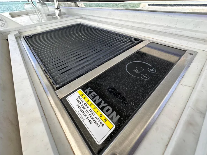  Yacht Photos Pics Kenyon grill on 2021 Tiara Sport 34 LS boat, featuring sleek design and safety warning.