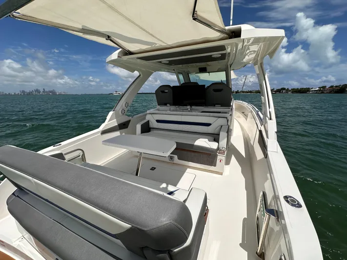  Yacht Photos Pics 2021 Tiara Sport 34 LS luxury boat on open water, featuring spacious seating and sleek design.