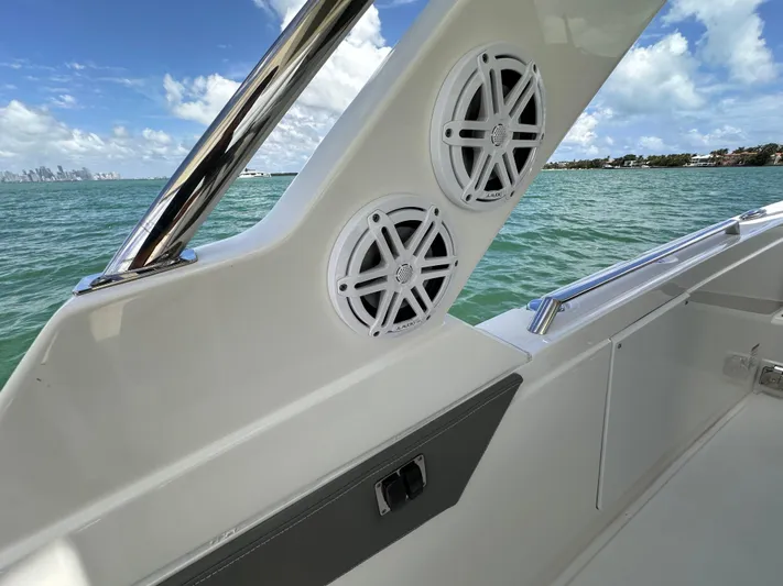  Yacht Photos Pics 2021 Tiara Sport 34 LS boat interior with speakers, ocean view, and clear sky.