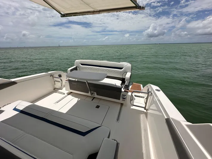  Yacht Photos Pics 2021 Tiara Sport 34 LS boat interior with ocean view and seating area.