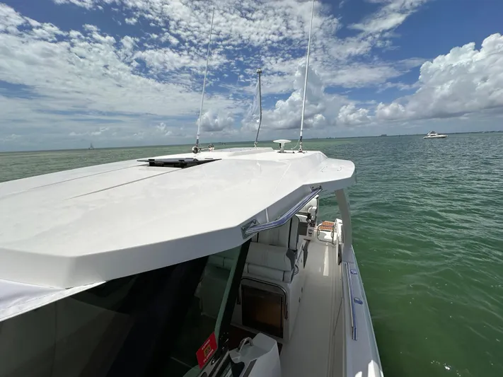  Yacht Photos Pics 2021 Tiara Sport 34 LS boat on calm sea under blue sky.