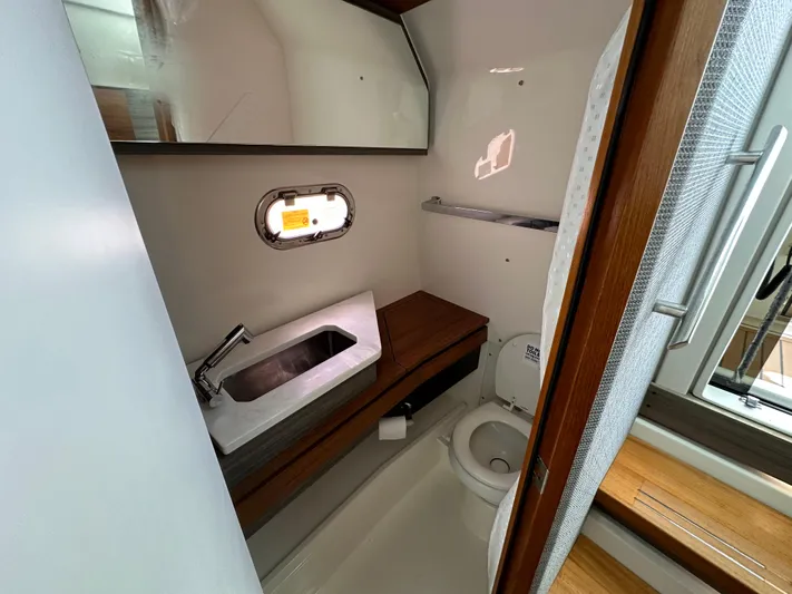  Yacht Photos Pics 2021 Tiara Sport 34 LS boat bathroom with sink, toilet, and window.
