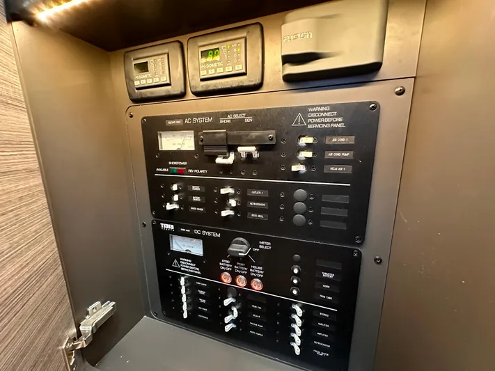  Yacht Photos Pics Control panel of a 2021 Tiara Sport 34 LS boat, featuring AC and DC systems.