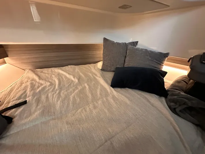  Yacht Photos Pics Cozy cabin interior of 2021 Tiara Sport 34 LS with pillows and soft lighting.