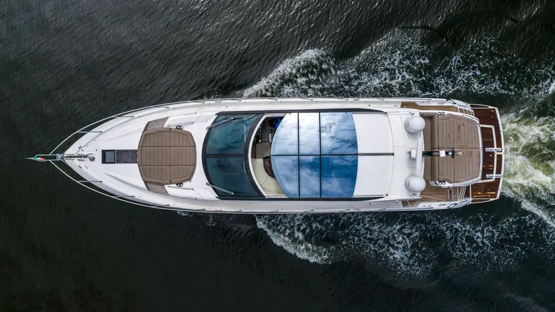 Yolo Yacht Photos Pics Aerial view of 2014 Sunseeker Predator yacht cruising on water.