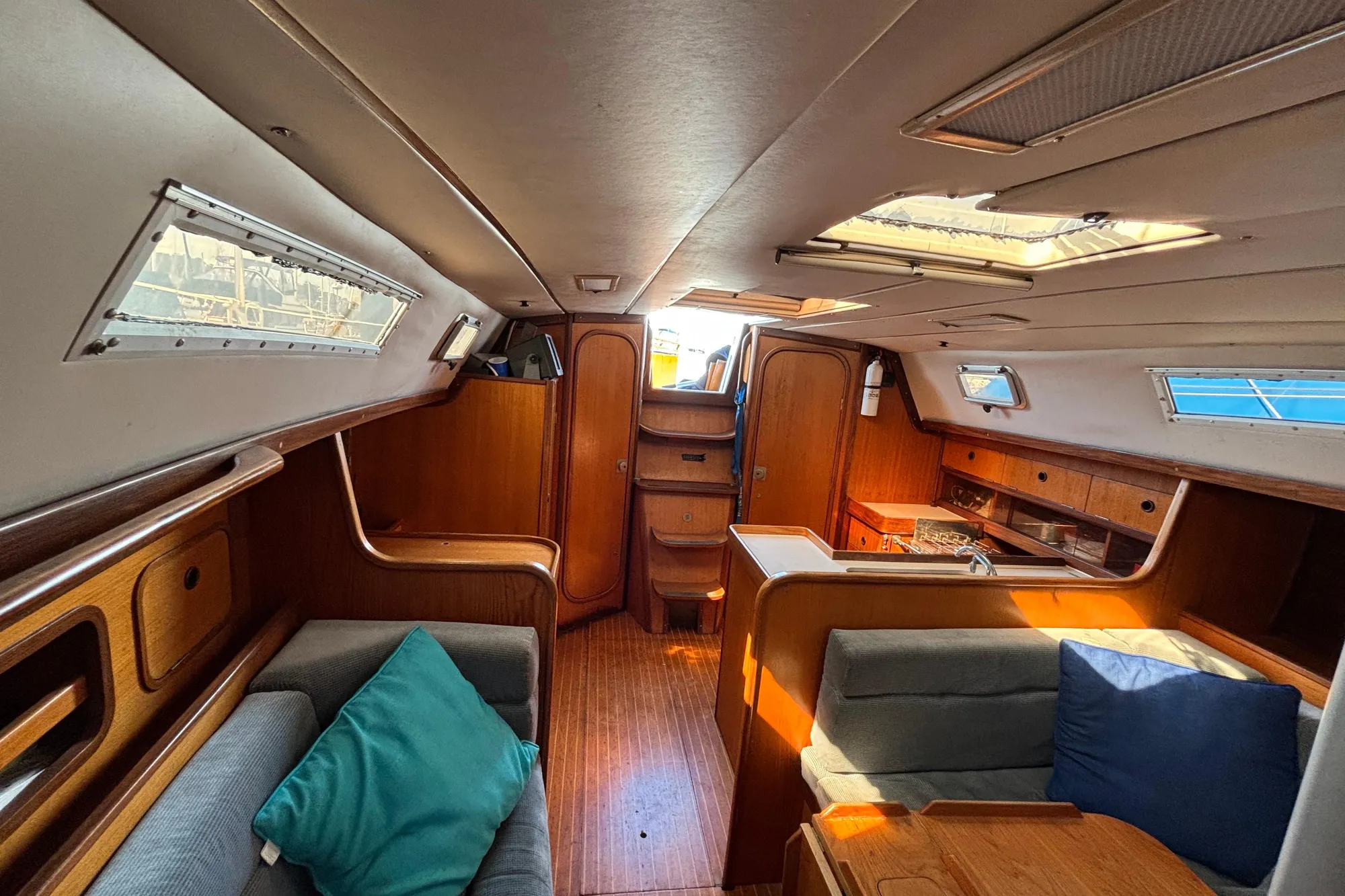 Interior of 1986 Beneteau First 375 sailboat with wood finish and seating area.