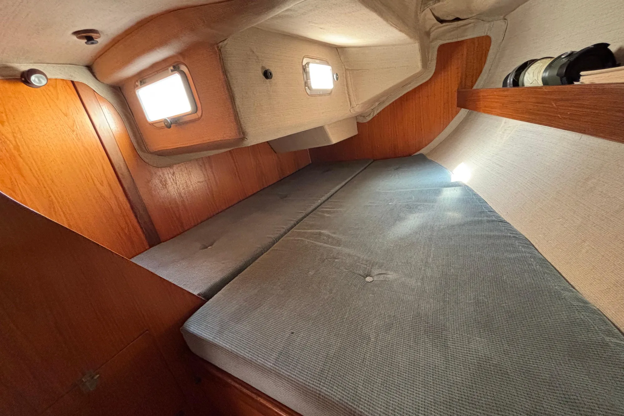 Cozy cabin interior of 1986 Beneteau First 375 sailboat with wooden accents.