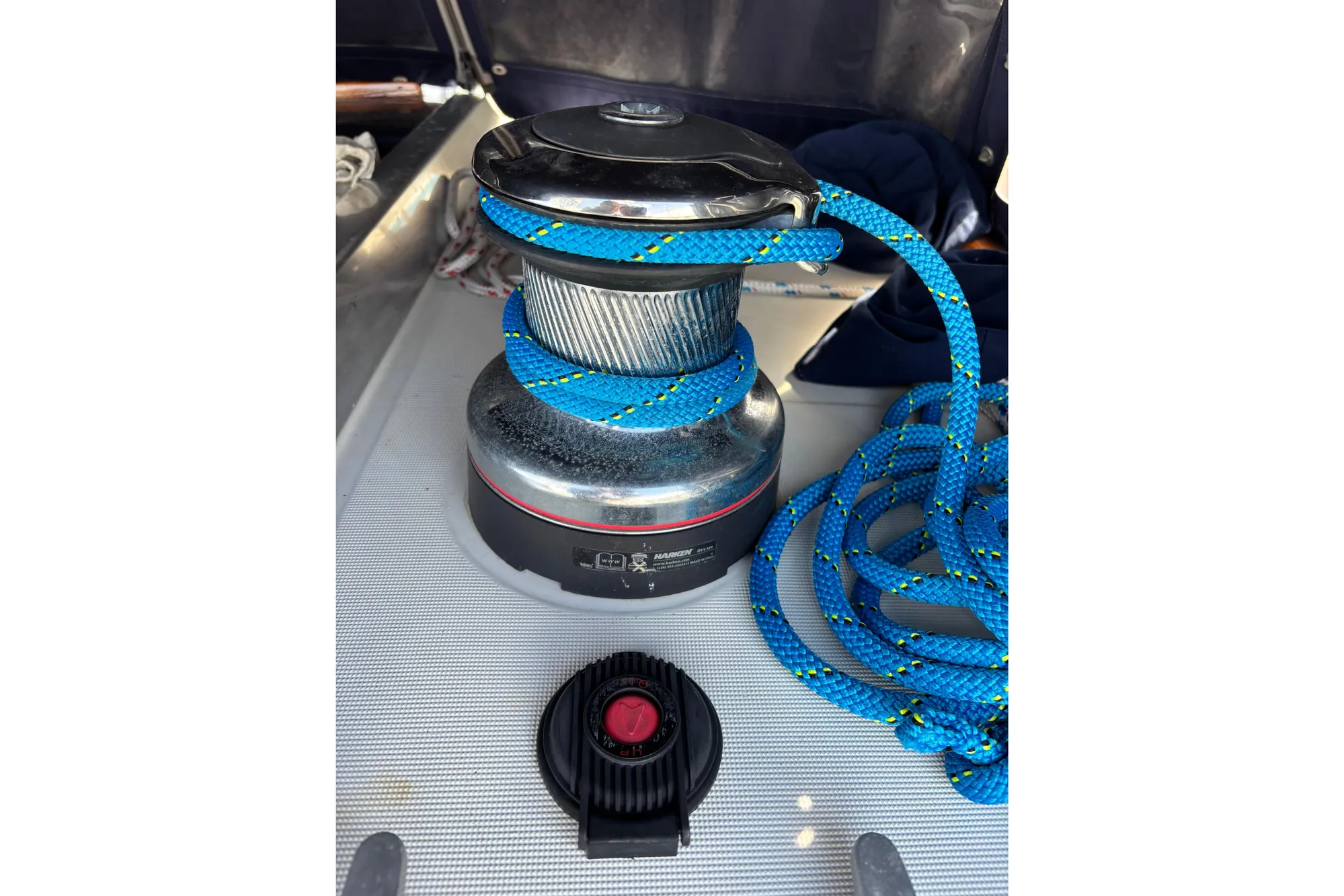 Winch with blue rope on 1986 Beneteau First 375 sailboat deck.