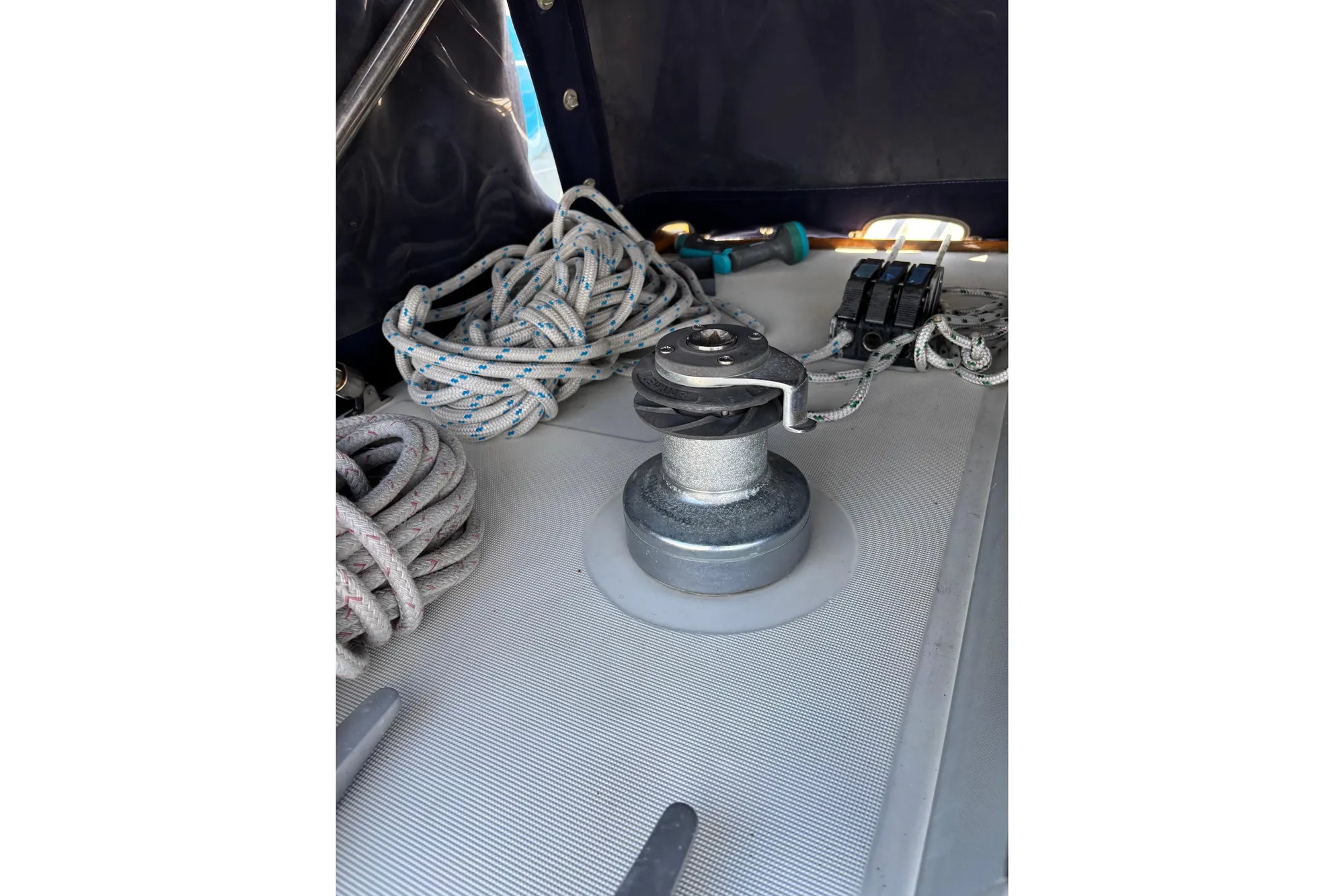 Winch and ropes on 1986 Beneteau First 375 sailboat deck.