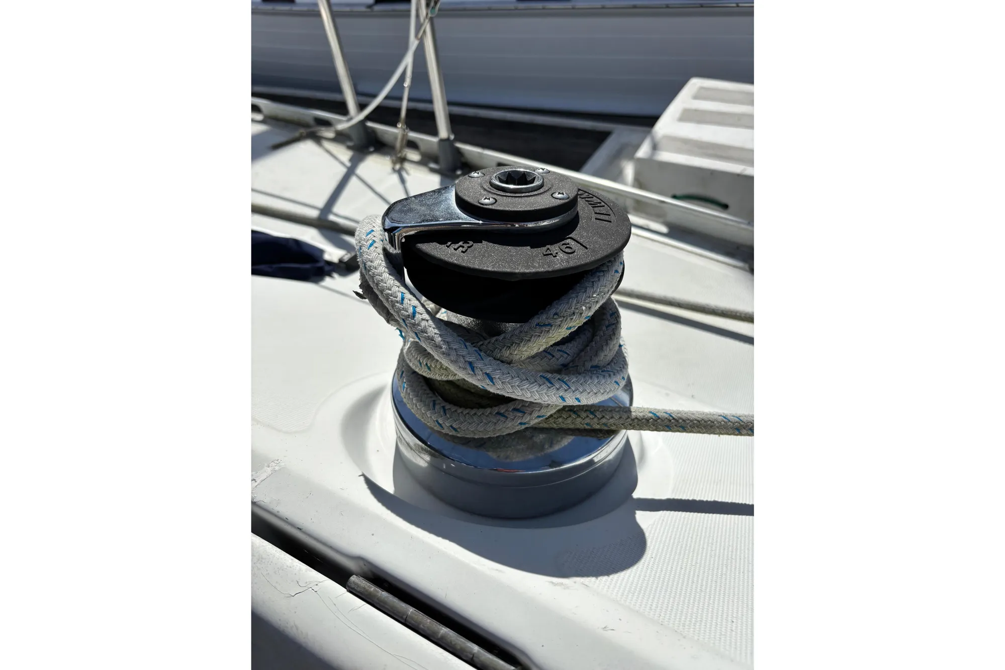 Winch and rope on 1986 Beneteau First 375 sailboat deck.