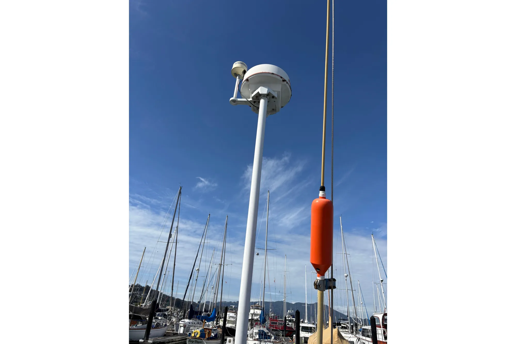 Sailboat masts and equipment on a Beneteau First 375, 1986, under a clear blue sky.