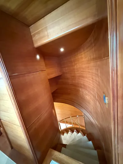 Sunrise Yacht Photos Pics Wooden staircase inside 2007 Ses Yachts SES 34, featuring elegant curved design.