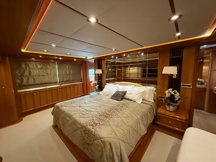 Sunrise Yacht Photos Pics Luxurious bedroom interior of 2007 Ses Yachts SES 34, featuring elegant wood paneling and ambient lighting.