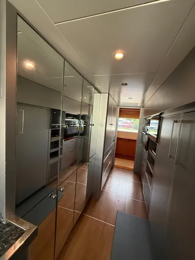 Sunrise Yacht Photos Pics Luxurious interior of 2007 Ses Yachts SES 34, featuring sleek cabinetry and modern lighting.