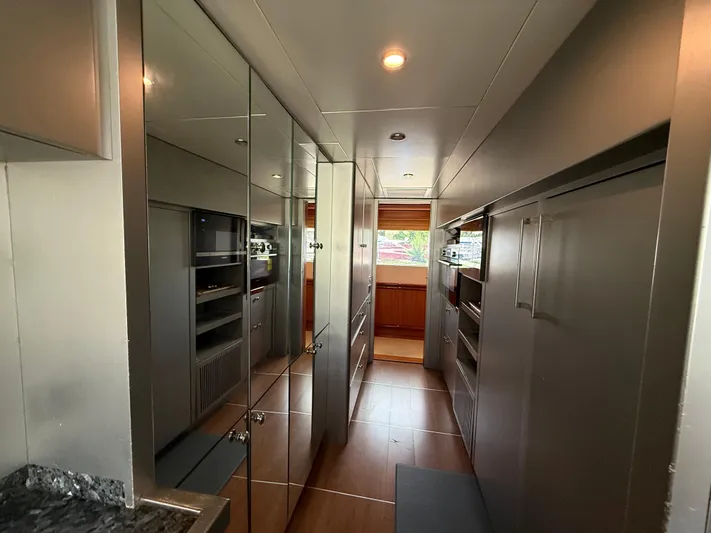 Sunrise Yacht Photos Pics Luxurious interior of 2007 Ses Yachts SES 34, featuring sleek cabinetry and modern design.