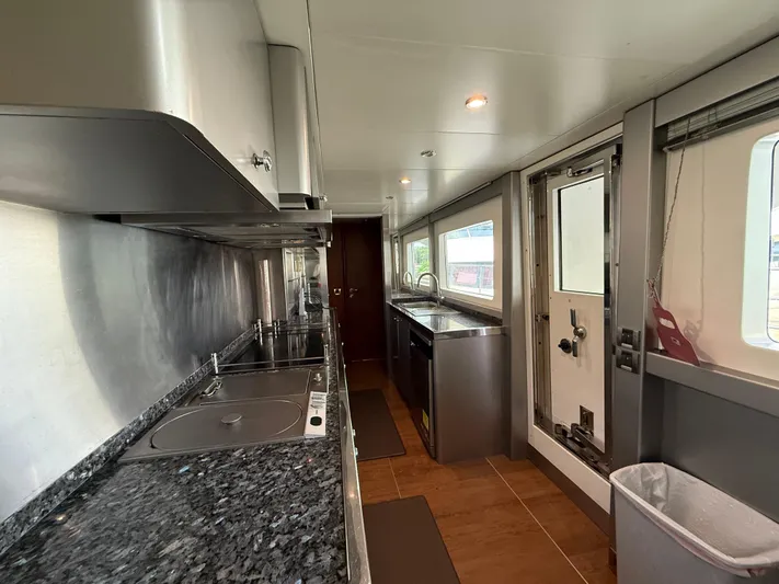 Sunrise Yacht Photos Pics Modern kitchen interior of 2007 Ses Yachts SES 34 with sleek countertops and appliances.