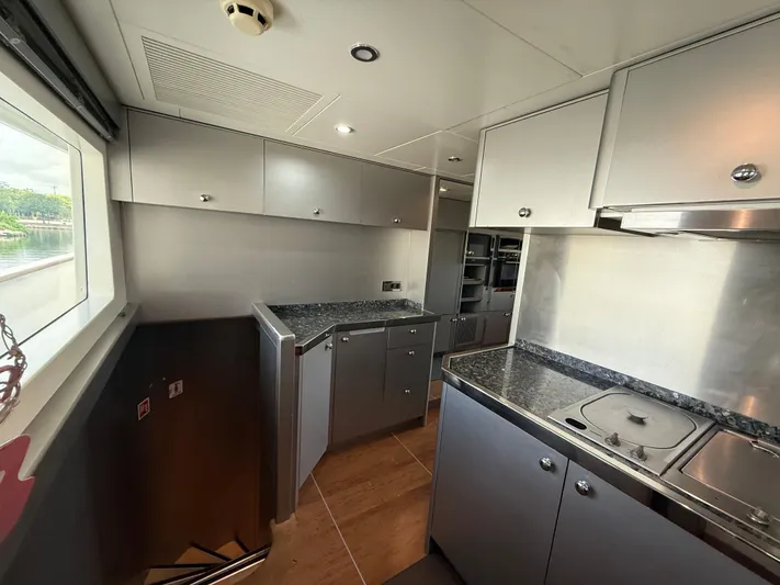 Sunrise Yacht Photos Pics Modern kitchen interior of 2007 Ses Yachts SES 34 with sleek cabinetry and countertops.