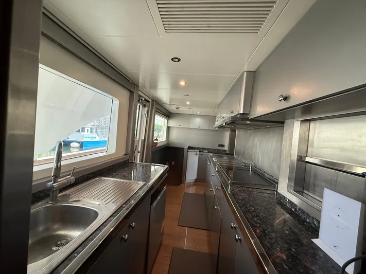 Sunrise Yacht Photos Pics Luxurious kitchen interior of 2007 Ses Yachts SES 34 with modern stainless steel appliances.