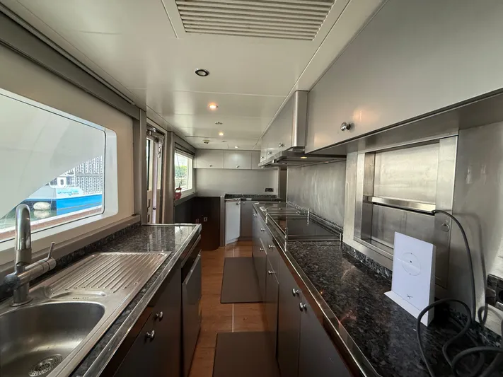 Sunrise Yacht Photos Pics Luxurious kitchen interior of 2007 Ses Yachts SES 34 with modern appliances and sleek design.