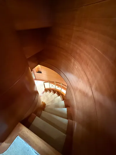 Sunrise Yacht Photos Pics Wooden spiral staircase inside 2007 Ses Yachts SES 34, showcasing elegant craftsmanship.
