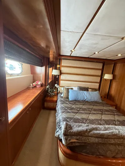 Sunrise Yacht Photos Pics Luxurious bedroom interior of 2007 Ses Yachts SES 34 with wood paneling and cozy bedding.