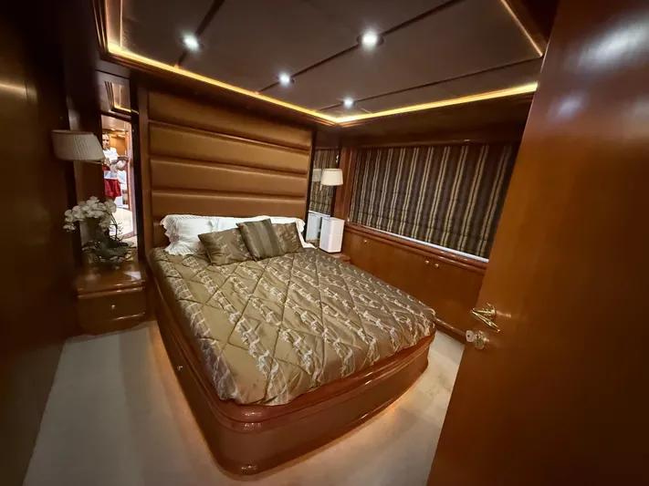 Sunrise Yacht Photos Pics Luxurious bedroom interior of 2007 Ses Yachts SES 34, featuring elegant wood paneling and ambient lighting.