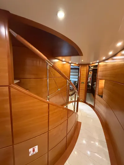 Sunrise Yacht Photos Pics Luxurious wooden interior of 2007 Ses Yachts SES 34, featuring elegant curved staircase.