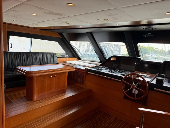 Sunrise Yacht Photos Pics Luxurious interior of 2007 Ses Yachts SES 34 with wooden finishes and steering wheel.