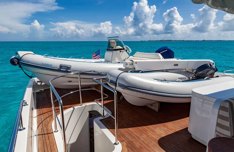 Sunrise Yacht Photos Pics Luxury yacht deck with inflatable boats, SES 34 model, 2007, on turquoise ocean waters.