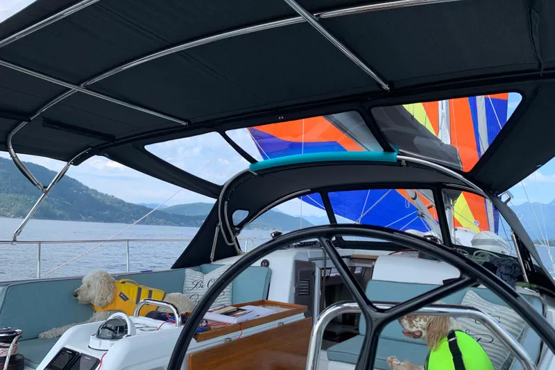 Lost Traveler Yacht Photos Pics Jeanneau Sun Odyssey 440 sailboat interior with colorful sails and dogs onboard, 2020 model.