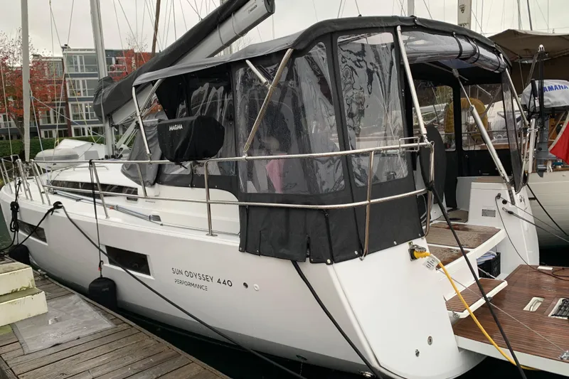 Lost Traveler Yacht Photos Pics 2020 Jeanneau Sun Odyssey 440 sailboat docked at marina with protective canopy.