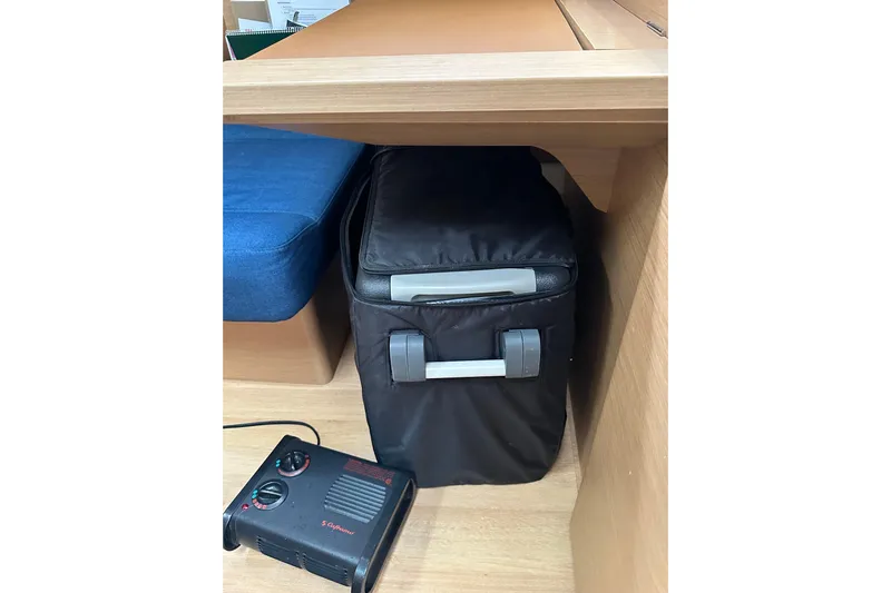 Lost Traveler Yacht Photos Pics Storage area in Jeanneau Sun Odyssey 440 yacht, featuring a portable cooler and heater.