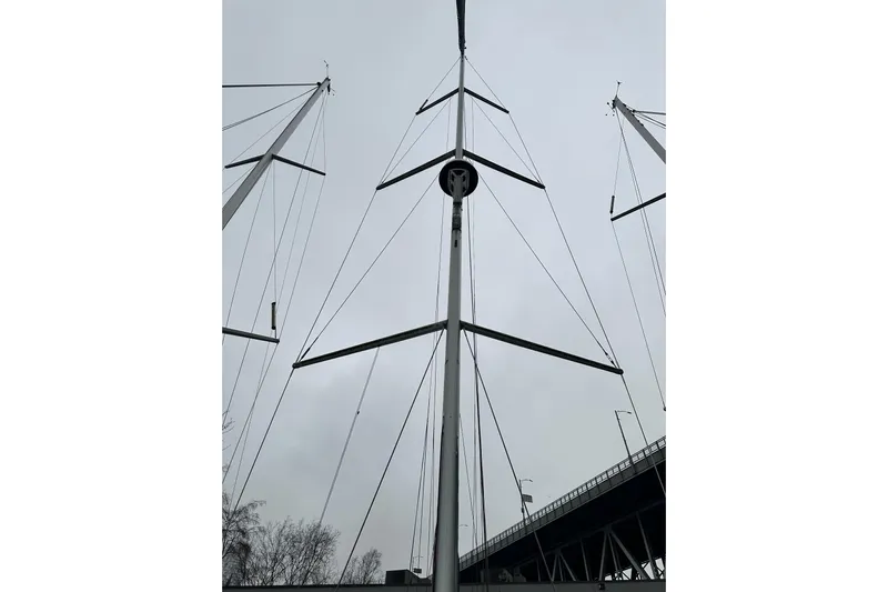 Lost Traveler Yacht Photos Pics Mast of 2020 Jeanneau Sun Odyssey 440 sailboat against cloudy sky.