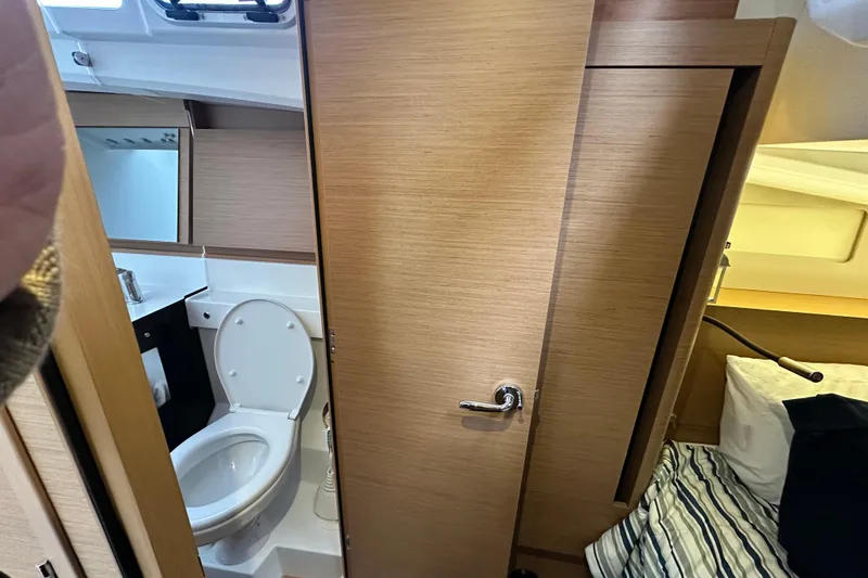 Lost Traveler Yacht Photos Pics Interior of 2020 Jeanneau Sun Odyssey 440, featuring a compact bathroom and cozy cabin.