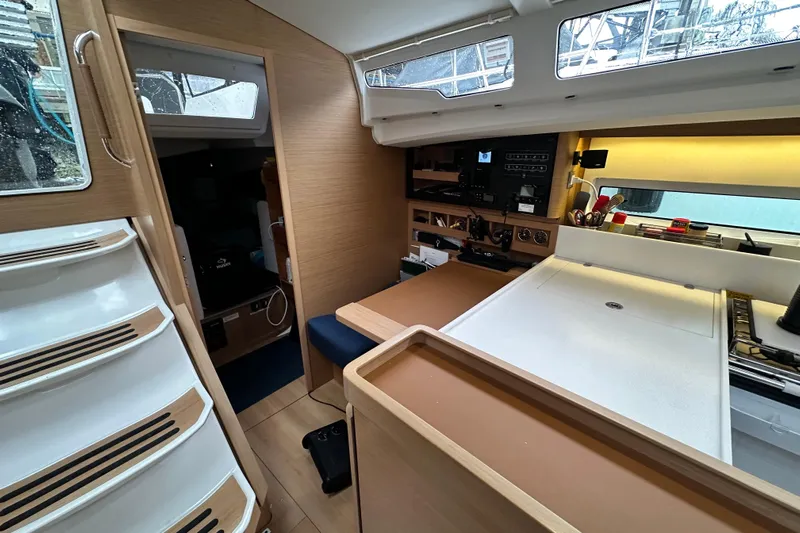 Lost Traveler Yacht Photos Pics Interior of 2020 Jeanneau Sun Odyssey 440 sailboat, featuring modern kitchen and navigation area.