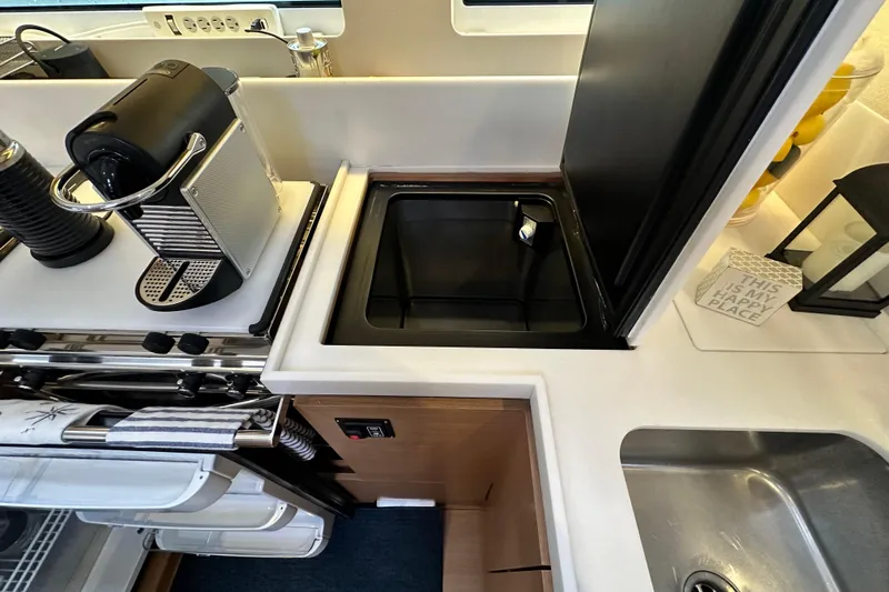 Lost Traveler Yacht Photos Pics Galley kitchen in 2020 Jeanneau Sun Odyssey 440 yacht with coffee maker and sink.