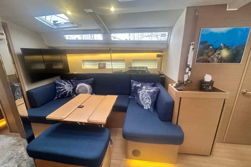 Lost Traveler Yacht Photos Pics Luxurious interior of 2020 Jeanneau Sun Odyssey 440 yacht with blue seating and modern decor.