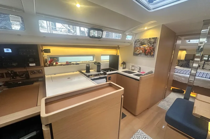 Lost Traveler Yacht Photos Pics Modern interior of 2020 Jeanneau Sun Odyssey 440 yacht, featuring a sleek kitchen and cozy cabin.