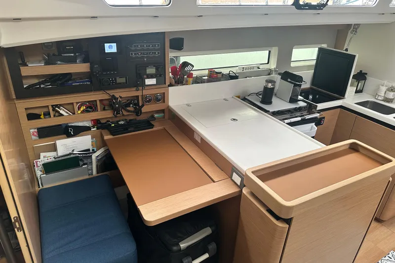 Lost Traveler Yacht Photos Pics Interior of 2020 Jeanneau Sun Odyssey 440 yacht, featuring a modern kitchen and navigation station.