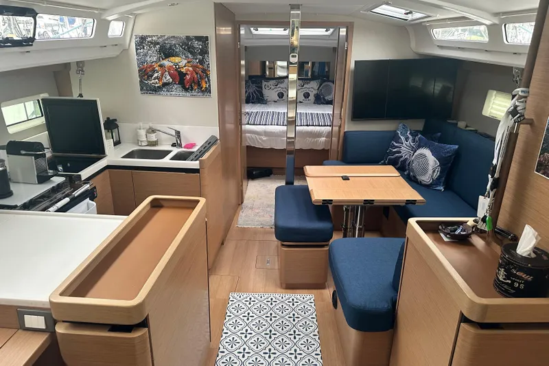 Lost Traveler Yacht Photos Pics Interior of 2020 Jeanneau Sun Odyssey 440 yacht with modern kitchen and cozy seating area.