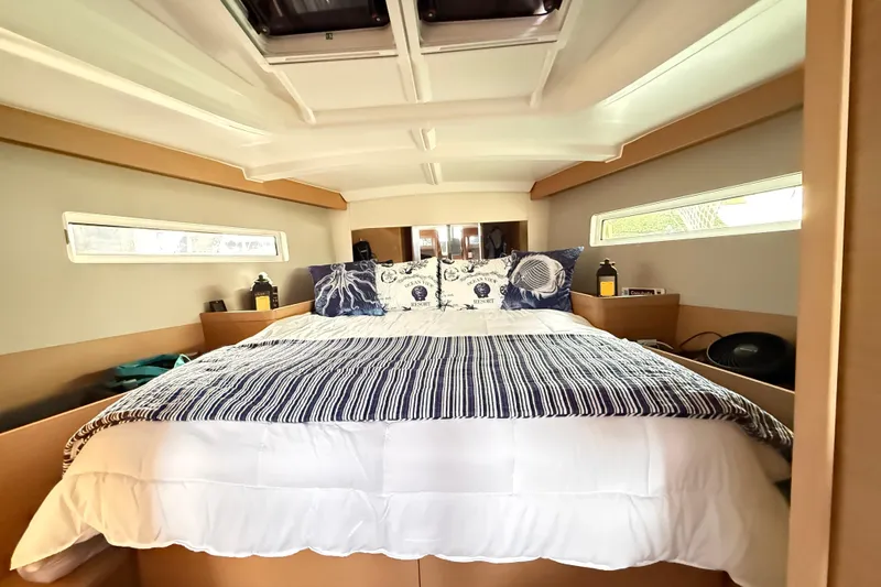 Lost Traveler Yacht Photos Pics Cozy cabin interior of 2020 Jeanneau Sun Odyssey 440 yacht with comfortable bedding.