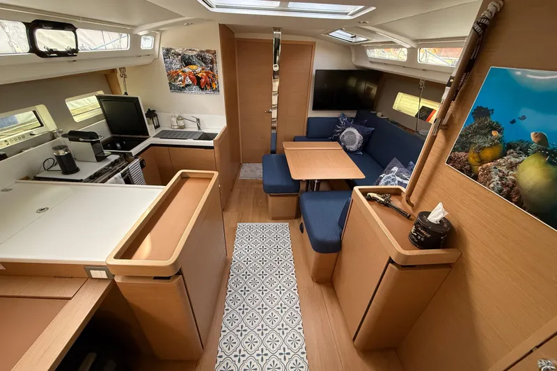 Lost Traveler Yacht Photos Pics Interior of 2020 Jeanneau Sun Odyssey 440 yacht, featuring modern kitchen and cozy seating area.